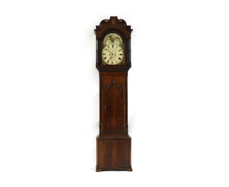 A Georgian eight day longcase clock, with painted moon face dial, the flame mahogany case with shell inlay and Gothic style d