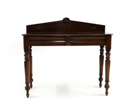 A Victorian mahogany serving table of architectural design, the raised back set with three roundels, above two moulded drawer