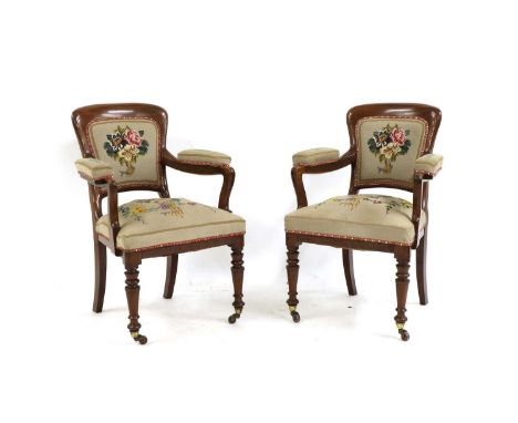 A pair of 19th Century mahogany elbow chairs, having tapestry seats and turned front legs with casters, 94cm high (2)Conditio
