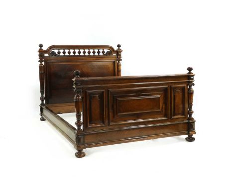 A French Louis XIV-style rosewood queen size bed, late 19th century, the panelled headboard with pierced and bobbin turned de