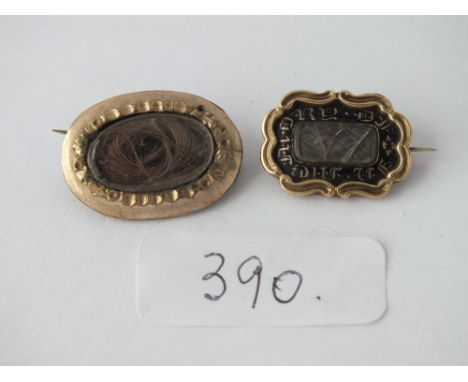 Two mourning brooches, one gold with black enamel &amp; another gilt one