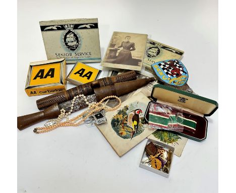 A collection of vintage photographs, handpainted bird figures, two Senior Service cigarette tins, two AA car badges, a steel 