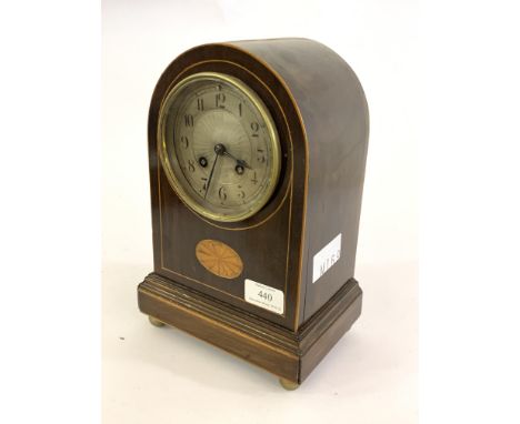 An Edwardian mahogany dome top mantel clock, the boxwood strung case inlaid with paterea, on a moulded base with brass ball s