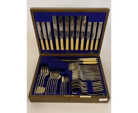 An Early 20th century EPNS canteen by Hamilton and Inches Edinburgh, the stained oak case with brass roundel initialled 'R' e