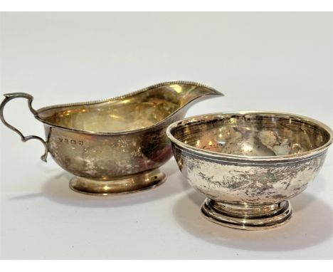 A modern Birmingham silver gadroon rimmed sauce boat with C scroll handle to side, (5cm x 14cm) (96.1g) a London silver bowl 