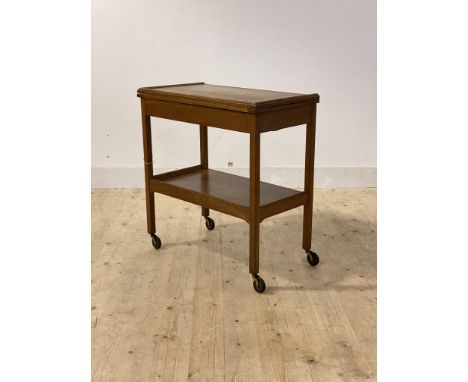 An early 20th century oak card table, the fold over revolving top revealing baize line playing surface, over drawer to one en