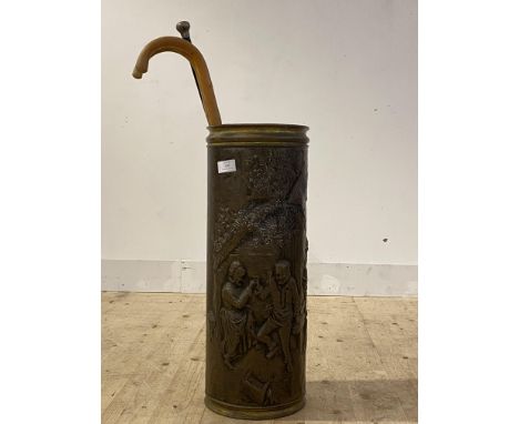 An embossed brass stick stand of cylindrical form (H65cm) together with an ebonised malacca cane walking stick with silver ha