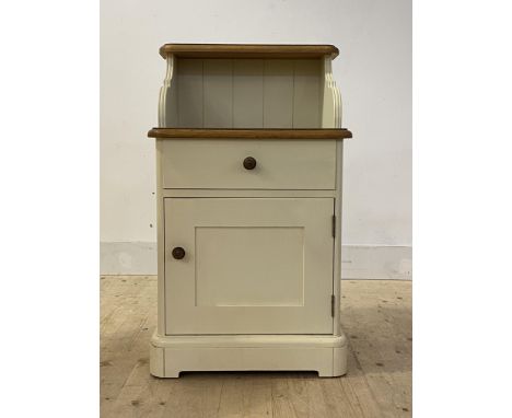 An oak and cream painted bedside, with open shelf over drawer and cupboard, H82cm