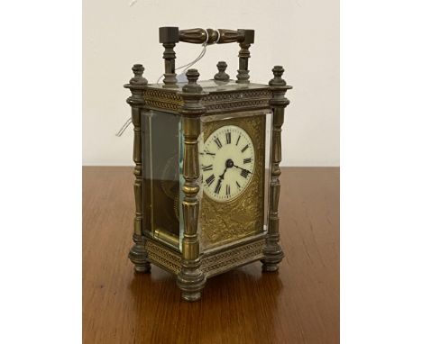 A late 19th/ early 20th century brass four glass carriage time piece clock, the case with swing handle over frieze and base w