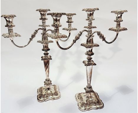 A pair of Victorian style Sheffield plated three branch candelabra with knop and circular tapered column and shaped stepped b