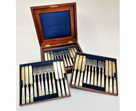An Edwardian mahogany canteen containing three trays with six mother of pearl handled engraved fruit knives and forks, shows 
