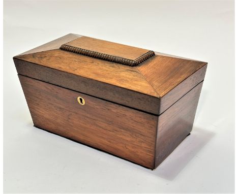 A 19thc rosewood sarcophagus shaped tea caddy, the top with fluted panel enclosing two tea sections and a centre space for mi