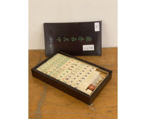 An early to mid 20th century Chinese resin mahjong set in a stained hardwood case, L27cm