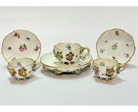 A pair of 19thc Meissen cabinet cups decorated with floral encrusted rose design with insects with matching pair of saucers a