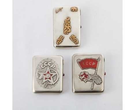 Group of three Russian sterling silver cigarette cases, all with applied decoration. Two with patriotic enameled hammer and s