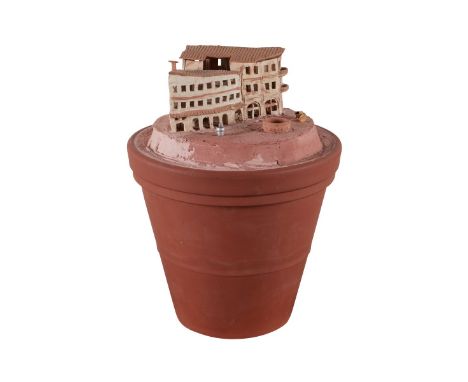 Aldo Moroni (American, 1953-2020). Ceramic and mixed media work depicting a building seated within a large ceramic pot. With 