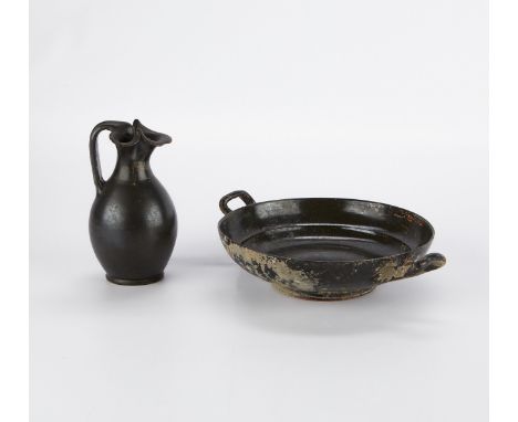 Group of two Greek ceramics including one low kylix and one oinochoe pitcher. The pitcher with applied decoration along the n