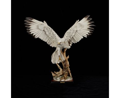 Giuseppe Armani (Italian, 1936-2006). Ceramic figure of a hawk landing on a branch, wings outstretched, titled "White Hawk." 