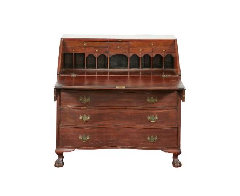 English drop front desk, the slant top concealing seven small drawers and numerous cubbyholes, over four graduated serpentine