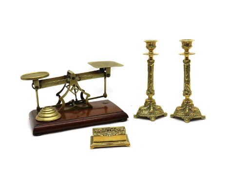 A set of Avery brass shop scales,20th century, on mahogany base with weights,together with a pair of brass candlesticks, in t