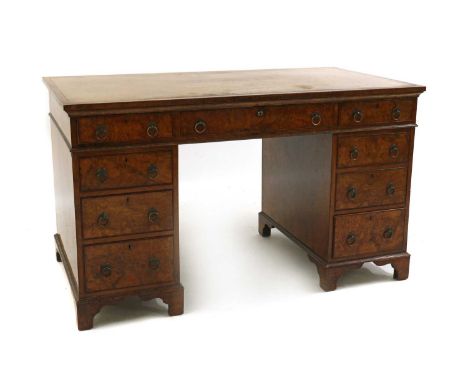 A Victorian walnut pedestal desk,the tooled and gilt leather inset top, over three frieze drawers and three-drawer pedestals,