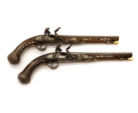 A pair of French 20 bore flintlock holster pistols,Belgium import marks for 1813-1814, border engraved flat bevelled locks, e