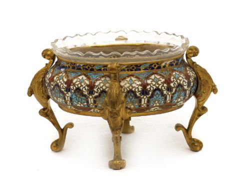 A French champlevé enamel jardinière,19th century, of oval form, with foliate decoration to a red, blue and cream ground, on 