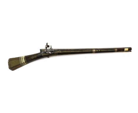 A Turkish Miquelet lock carbine,late 18th century, with 64cm sighted octagonal demascus rifled barrel decorated with silver s