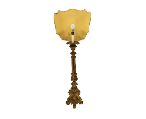 A gilt brass altar stick table lamp,late 19th century, with foliate cast decoration, and Chi Rho symbols to the base, with a 