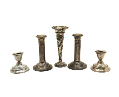 A collection of silver candlesticks, comprising a pair of dwarf examples, by William Hair Haseler, 1912, and a further pair b