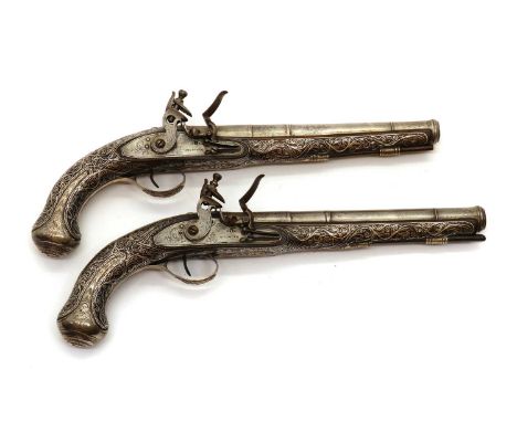 A pair of Turkish 14 bore silver mounted flintlock holster pistols,late 18th century in the European style, flat locks with f