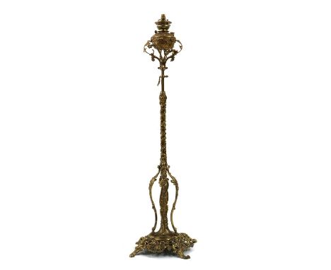 A Victorian brass rise and fall standard lamp, converted to electricity, the reservoir cap marked ‘Thermidor Belge’, with a c