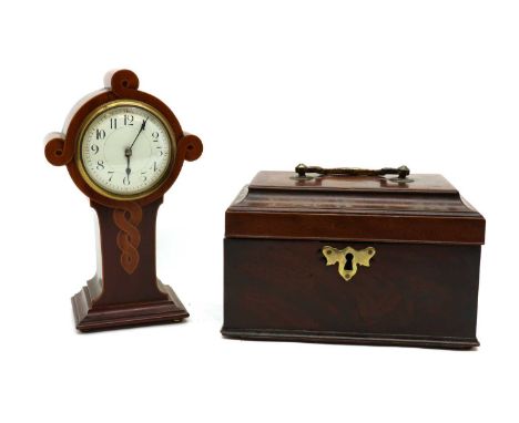 A George III mahogany tea caddy, the shaped rectangular top fitted brass handle opening to reveal unfitted interior, 25cm wid