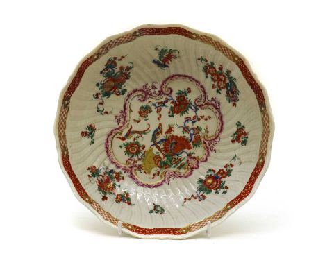 A large Worcester porcelain shallow bowl, 18th century, in the manner of James Giles, decorated with birds to a wrythen mould