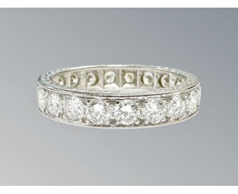 A platinum diamond eternity ring, channel set with twenty brilliant-cut stones, the total diamond weight estimated at 2.0 car