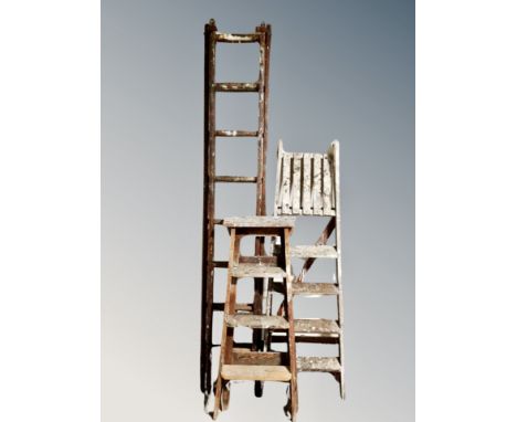Two wooden step ladders and a further wooden ladder 