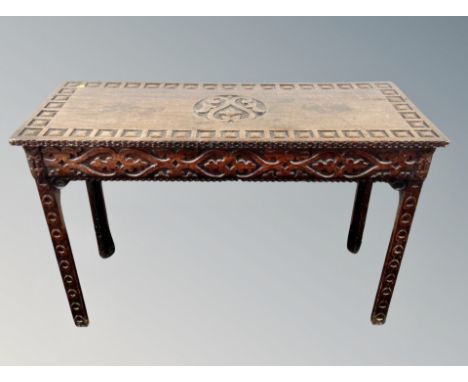 A George III and later carved oak side table, width 105 cm  CONDITION REPORT: Historic ring marks to the top and also a natur