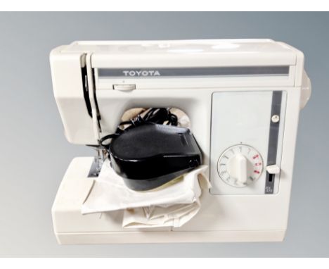 A Toyota sewing machine model EX1 with foot pedal and lead.