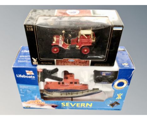 A remote controlled life boat together with a die cast gold plated Ford Model T fire engine.