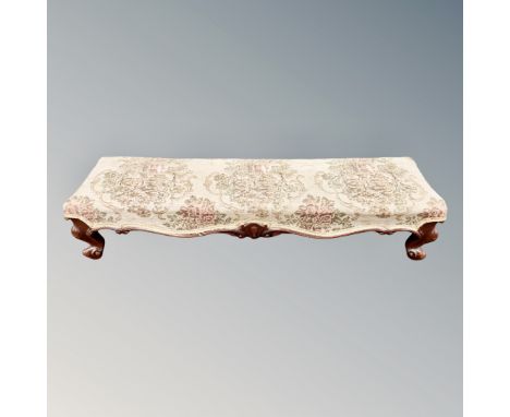 A rectangular long footstool in tapestry fabric together with a further footstool 
