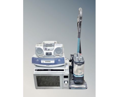 An Aiwa hifi together with Panasonic portable stereo, Panasonic dvd recorder, Russell Hobbs microwave and Shark vac 