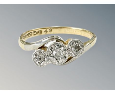 An 18ct gold and platinum three stone diamond ring, size K. CONDITION REPORT: 2.4g