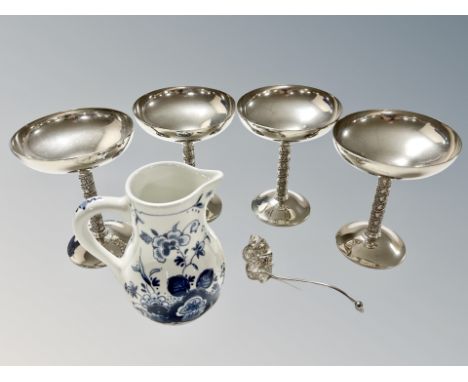 Four silver plated goblets, caddy spoon and a delft jug 