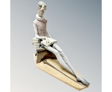 A Nao figure of a seated Don Quixote with sword on plinth 