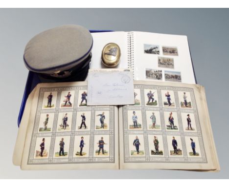 Two albums of German cigarette cards depicting miliary figures, a Luffwaffe cap, brass snuff box, German postcards 