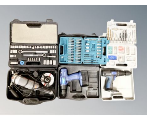 A box of tools including Performance grinder, two hand drills (lacking batteries), cases of screws, a case of drill bits.
