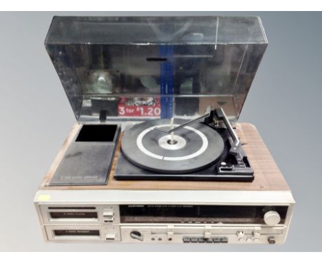 A Lloytron AM/FM stereo dual eight track play recorder with turntable above