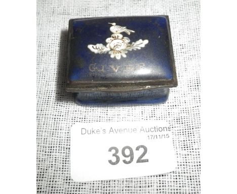 AN ENAMEL PATCH BOX, inscribed 'Remember the Giver', decorated with a bird and flowers in white, against a deep blue ground