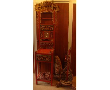 A CHINESE RED LACQUERED STAND with two fitted drawers and giltwood decoration and a similar standard lamp (examine)
