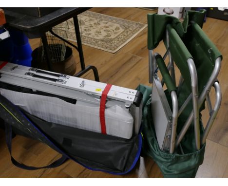 Large folding portable camping table in storage bag and folding camp bed